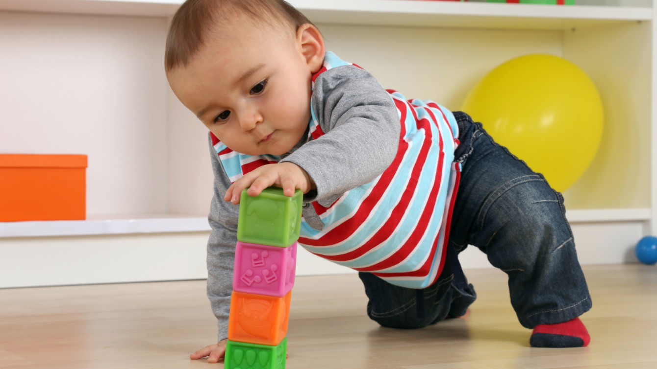 Infant playing with blocks on flood